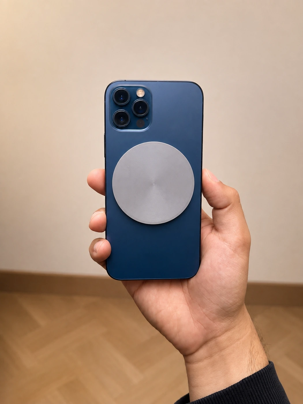 Gray Forje Link attached to a blue iPhone