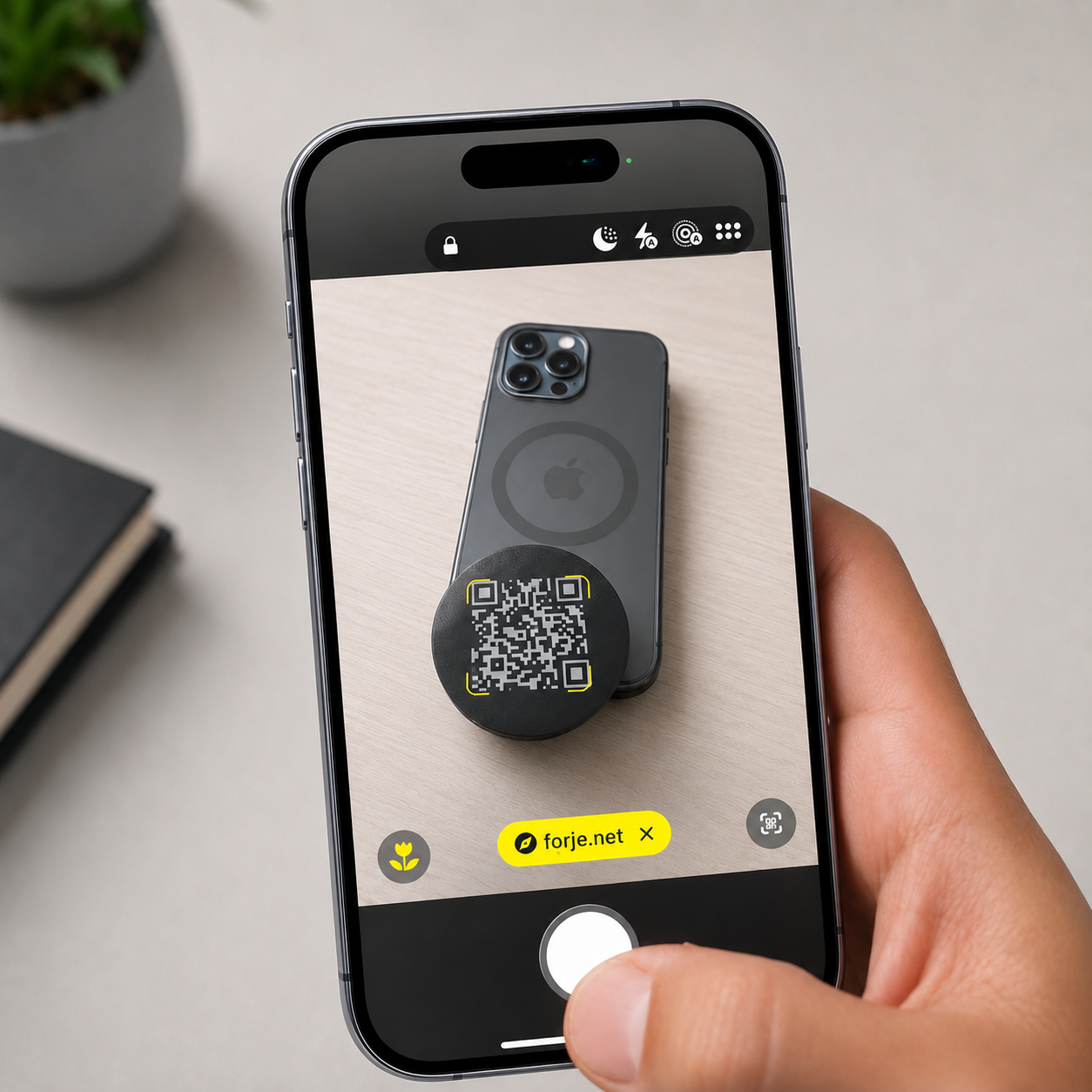 A phone scanning the QR code on a Forje Sigil